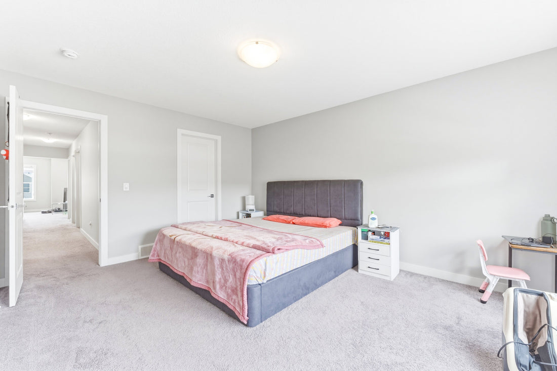 Primary bedroom in a five-bedroom Calgary home at 14 Belvedere Point SE